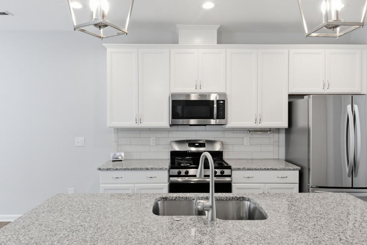 Kitchen with granite counters and stainless range in the Garner townhouse rental