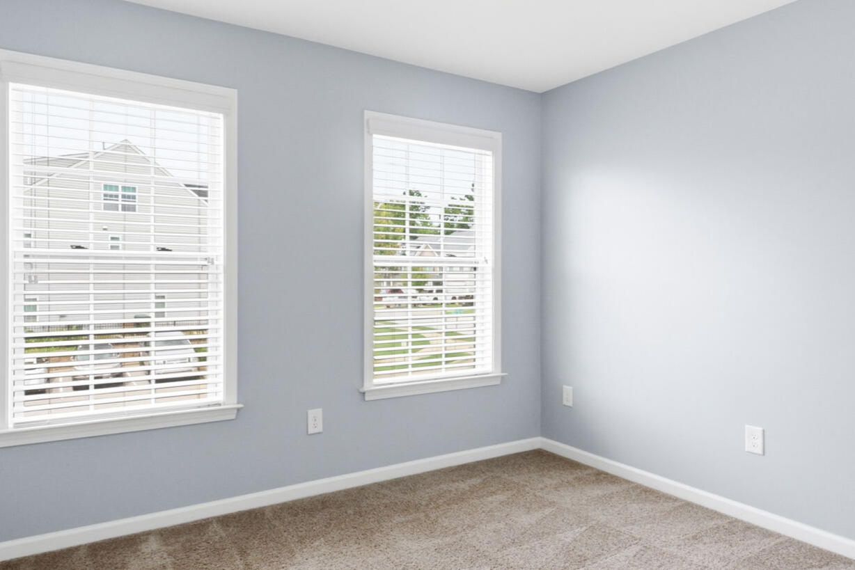 Bedroom with large windows in the Garner, NC townhouse rental